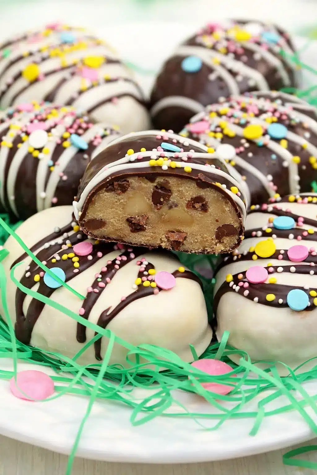 Peanut butter cookie dough Easter eggs coated in chocolate with pastel sprinkles