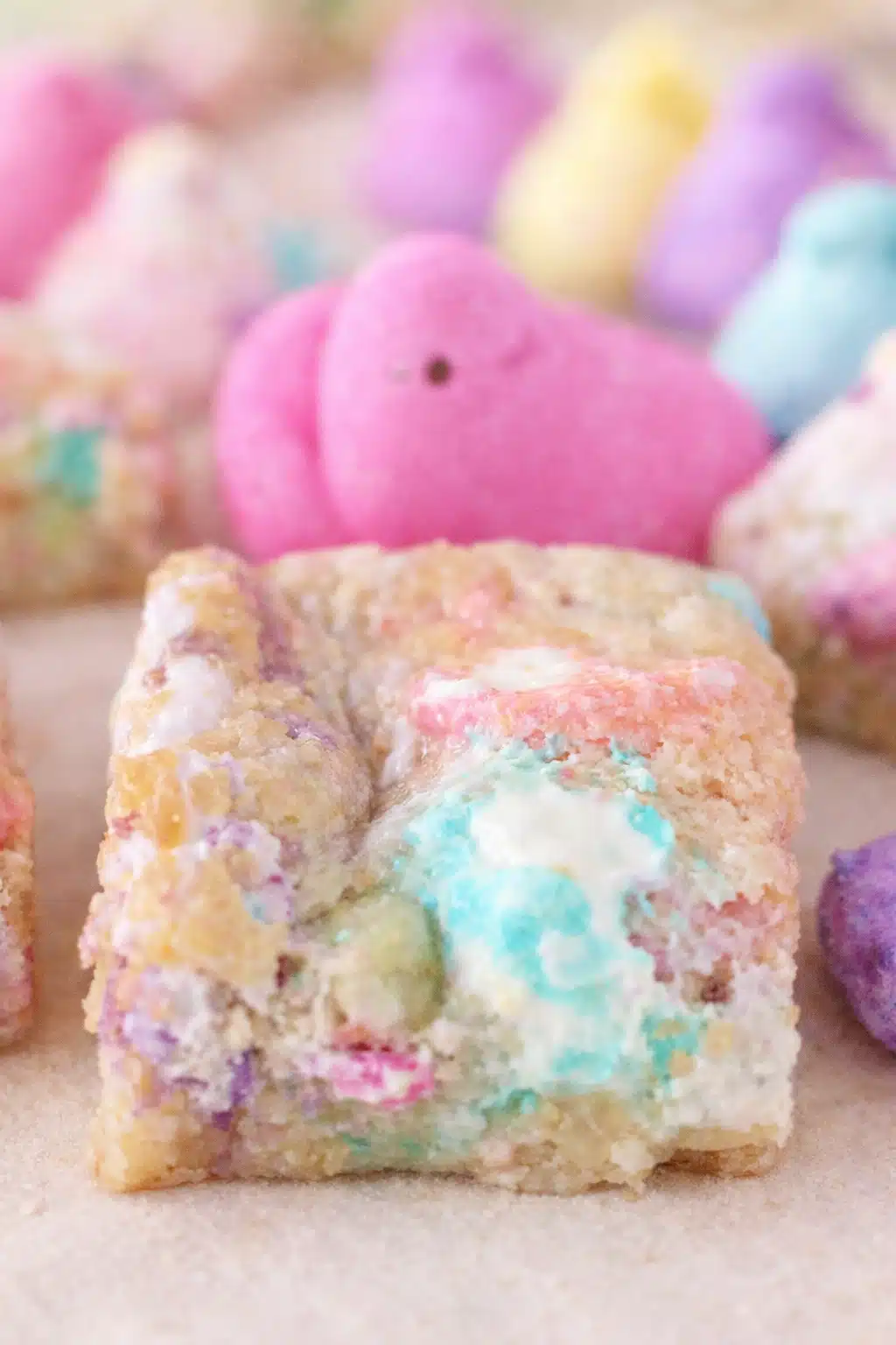 home 6 Chewy Peeps sugar cookie bar with pastel marshmallow swirls and colorful marshmallow chicks in the background.