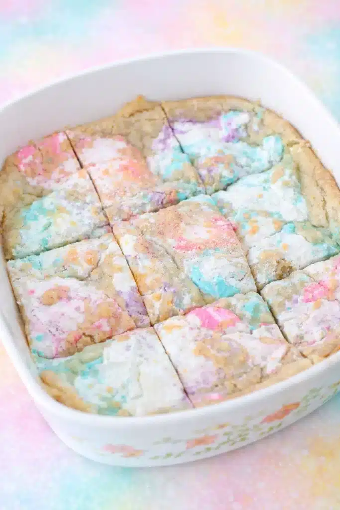 Easter Peeps Sugar Cookie Bars Recipe 10 Peeps Sugar Cookie Bars in a white dish with pastel marshmallow swirls