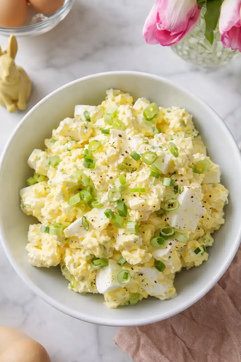 home 7 Creamy quick Easter egg salad topped with green onions in a pastel bowl