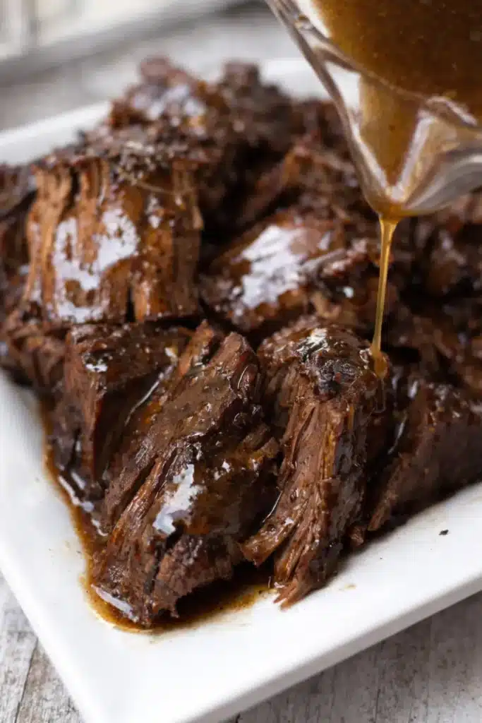 Crock Pot chuck roast drizzled with rich brown gravy