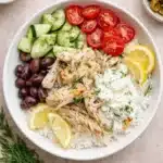 Slow cooker Greek chicken bowl with rice, tzatziki, tomatoes, cucumbers, and olives