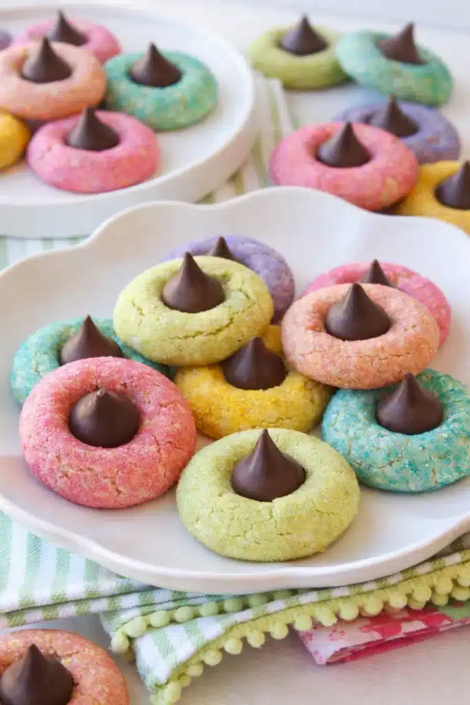 Pastel spring blossom cookies with chocolate centers on a white plate