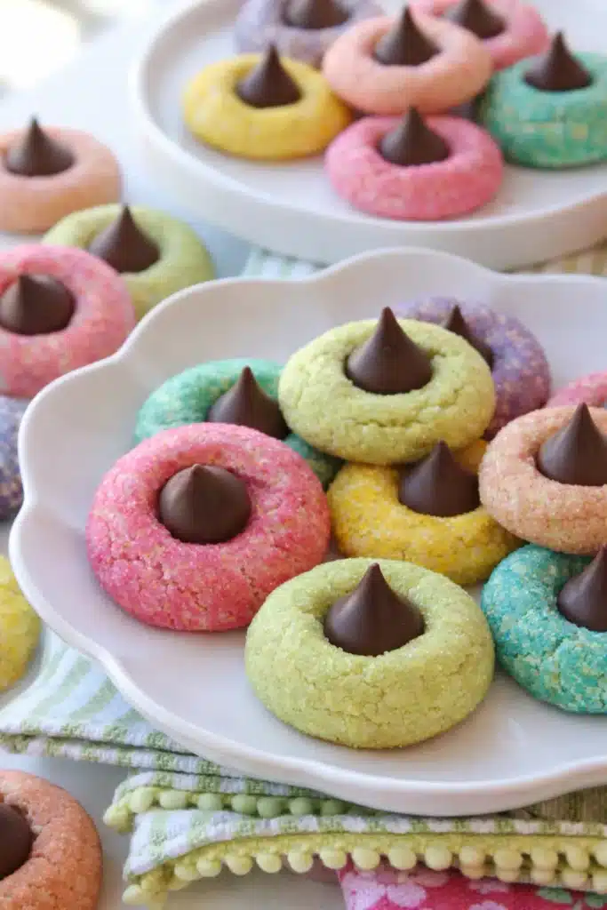 Colorful spring blossom cookies with chocolate centers on white plate