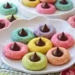 Colorful spring blossom cookies with chocolate centers on white plates