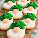 St. Patrick’s Day gnome cookies with green hats and white royal icing beards on marble board