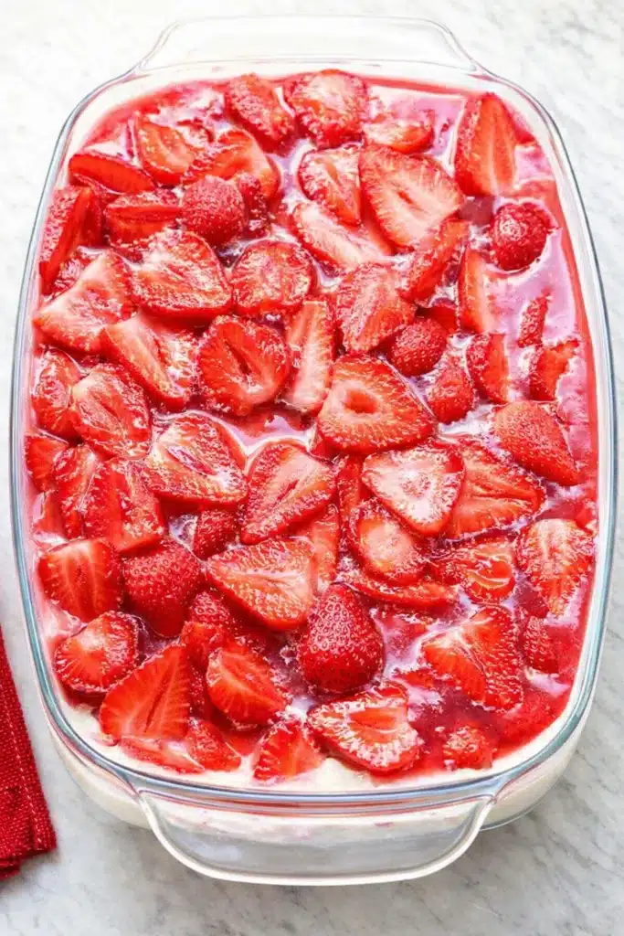 Strawberry Heaven Cake | Amazing No-Bake Dessert Recipe 5 Strawberry Heaven Cake topped with glossy strawberries in a glass baking dish