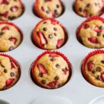 Strawberry protein muffins with chocolate chips in muffin tin