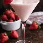 Creamy strawberry shortcake martini with fresh strawberries on table