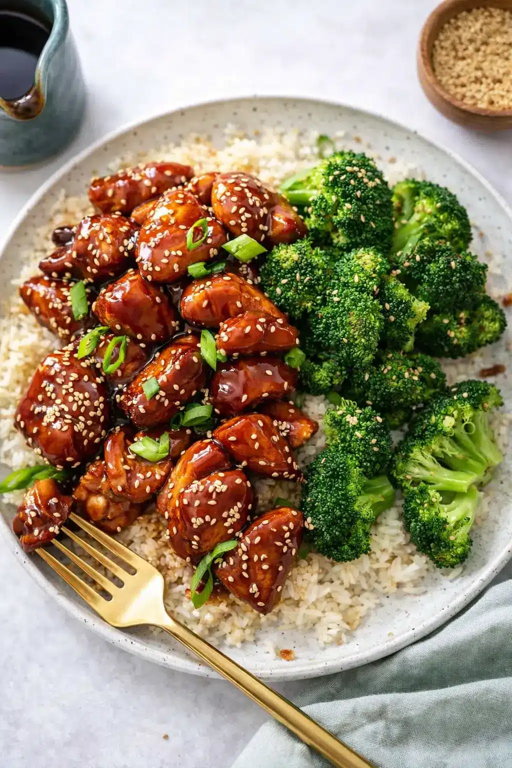 Air fryer teriyaki chicken with rice and broccoli topped with sesame seeds