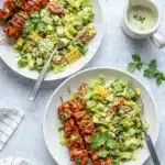 BBQ chicken skewer salad with grilled corn, avocado, tomatoes, and creamy herb dressing