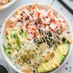 California roll sushi bowl with crab, avocado, cucumber, rice and spicy mayo drizzle