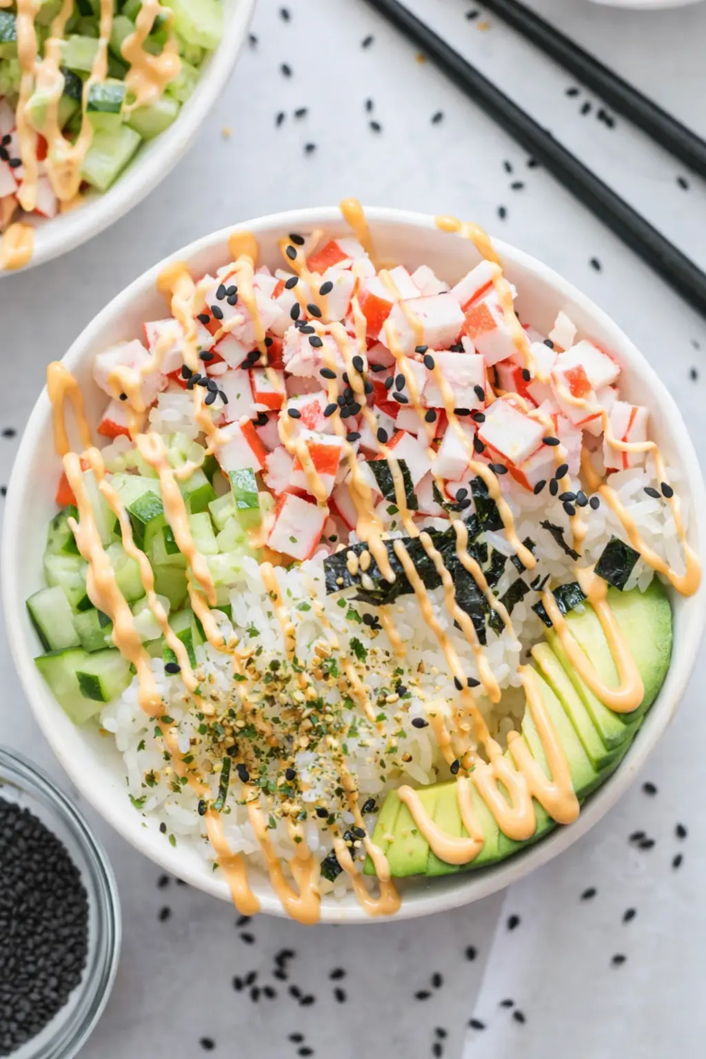 California roll sushi bowl with crab, avocado, cucumber, rice and spicy mayo drizzle