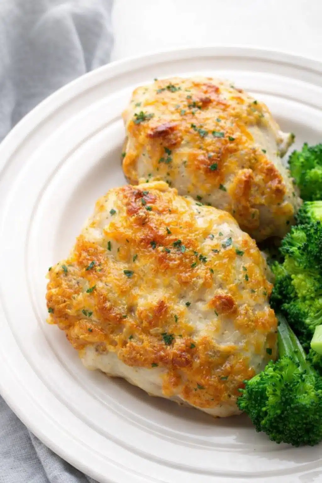 Cheddar ranch chicken thighs with melted cheese topping served with broccoli