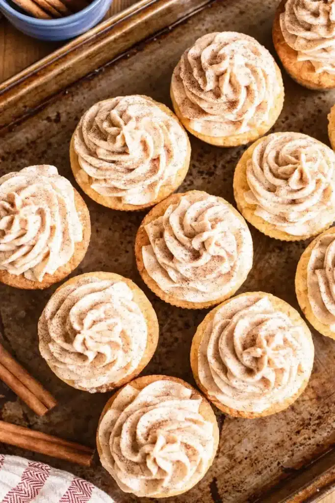 Churro Cupcakes on a rustic baking sheet with cinnamon frosting