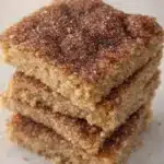 Cinco de Mayo churro bars stacked with cinnamon sugar topping and soft buttery crumb