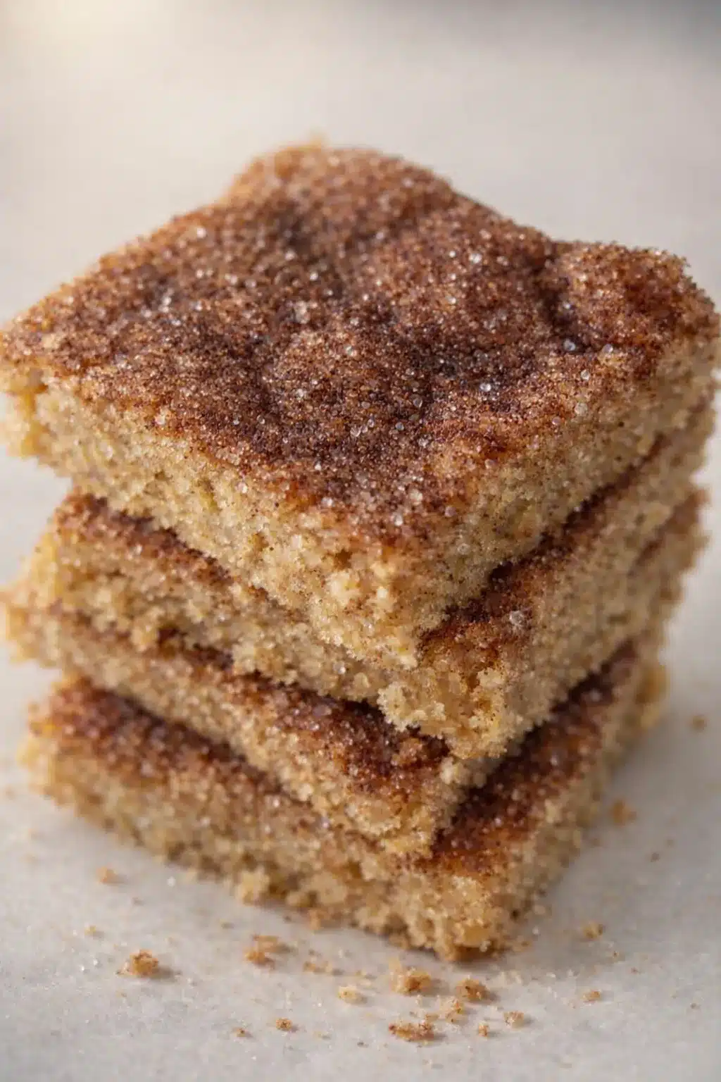 Cinco de Mayo churro bars stacked with cinnamon sugar topping and soft buttery crumb
