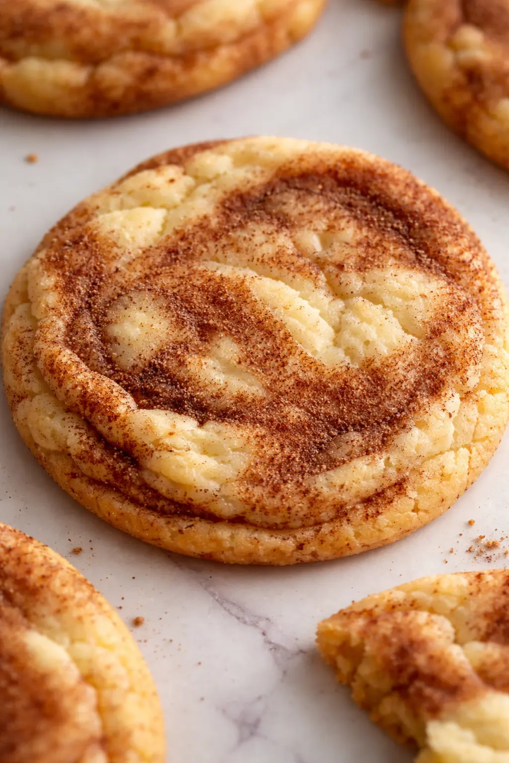 Cinnamon roll sugar cookie with soft center and cinnamon swirl topping