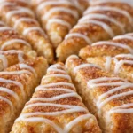 Cinnamon sugar crescent pizza slices with vanilla glaze drizzle on flaky golden pastry