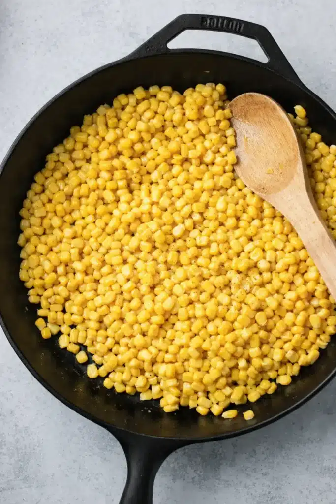 Street corn salad corn kernels cooking in skillet
