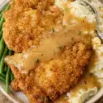 Country fried chicken with mashed potatoes and gravy served with green beans