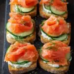 Smoked salmon tea sandwiches with cucumber, cream cheese and dill on toasted bread