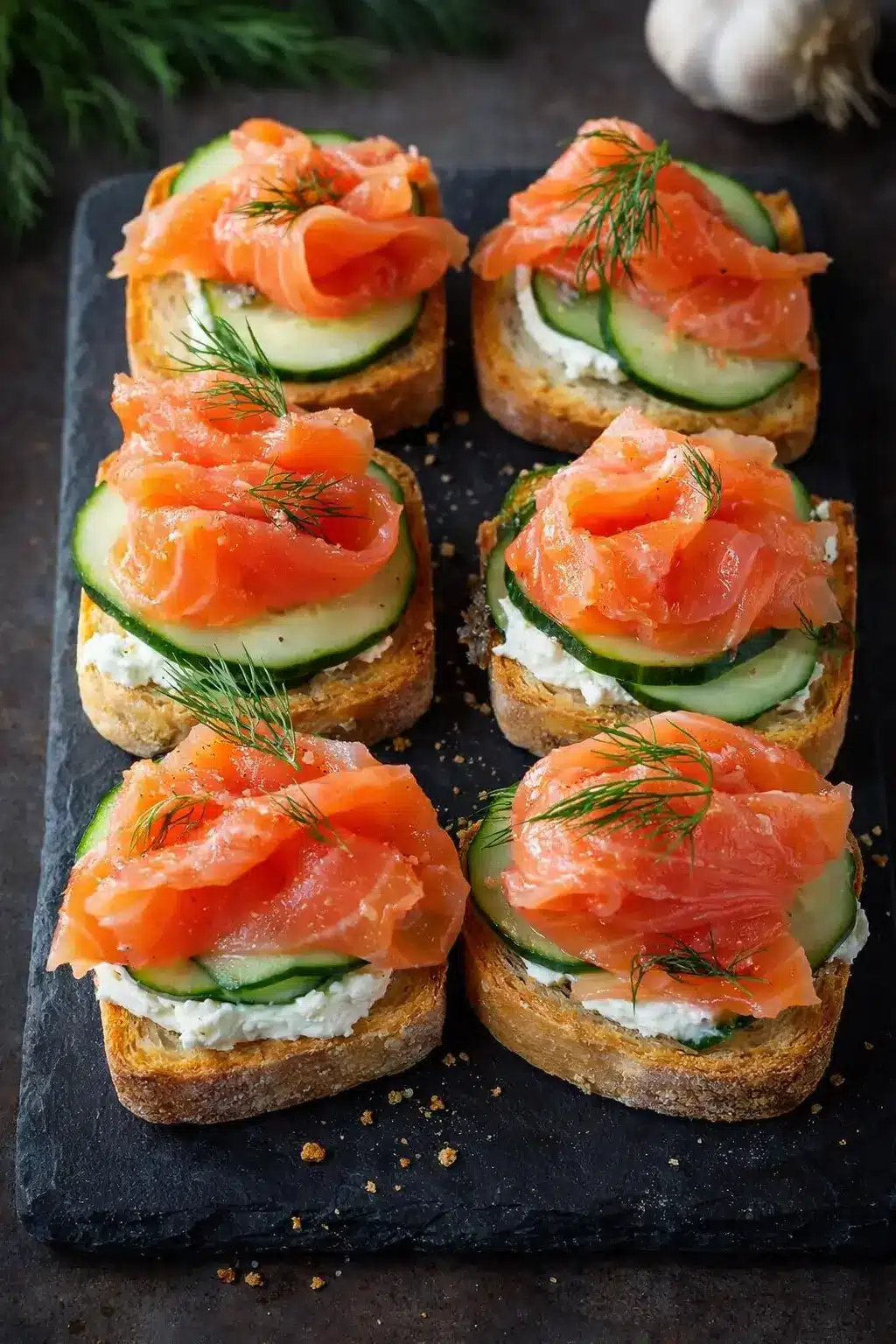 Smoked salmon tea sandwiches with cucumber, cream cheese and dill on toasted bread