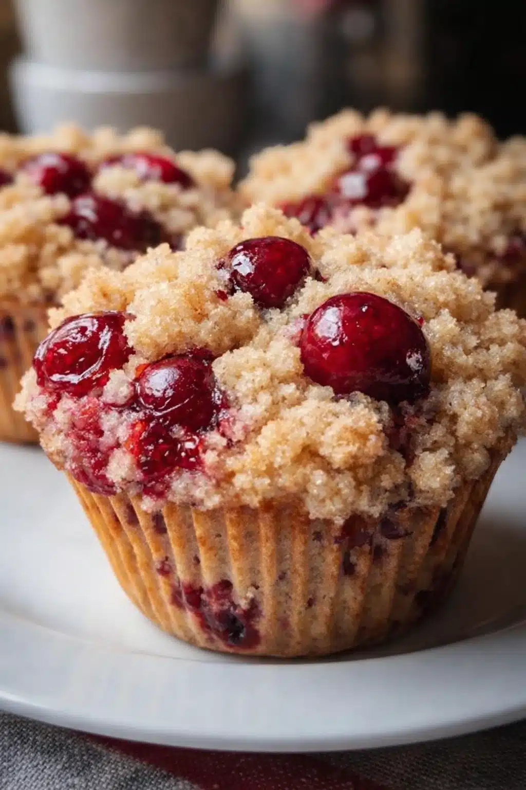 Easy cherry cobbler muffin with crumbly streusel topping and juicy cherries on a plate