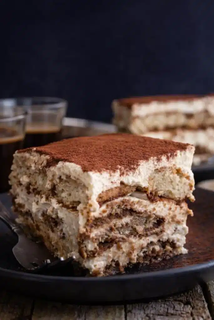 Easy tiramisu slice with mascarpone layers and cocoa powder on a plate