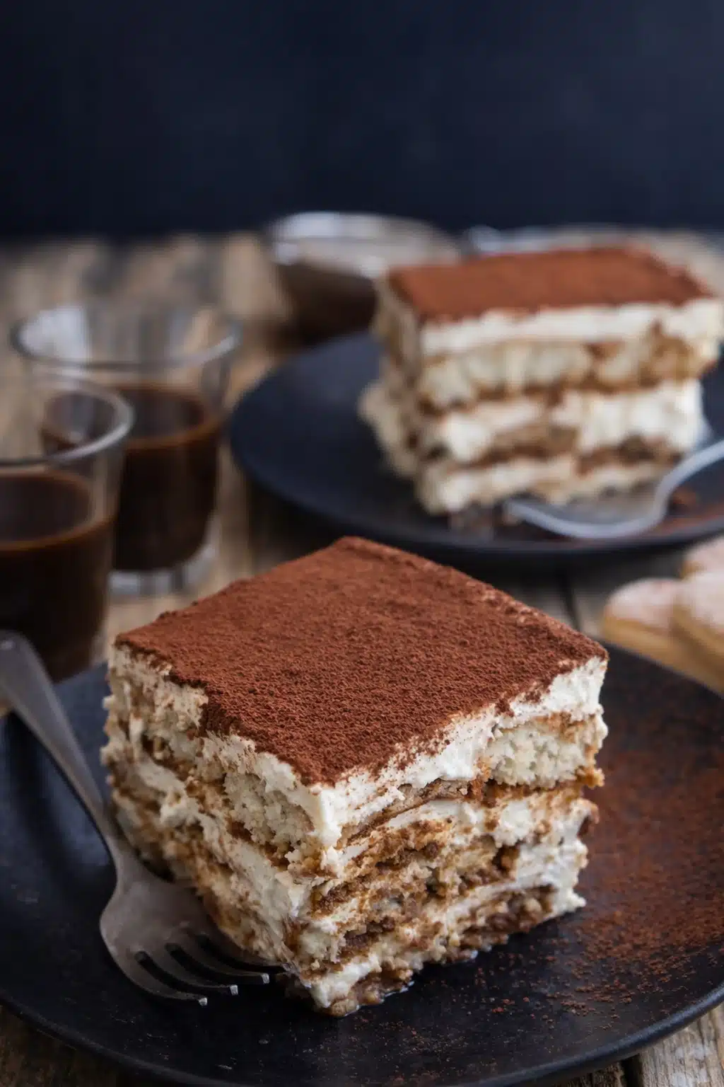 Easy tiramisu slice with mascarpone layers and cocoa powder served on a plate