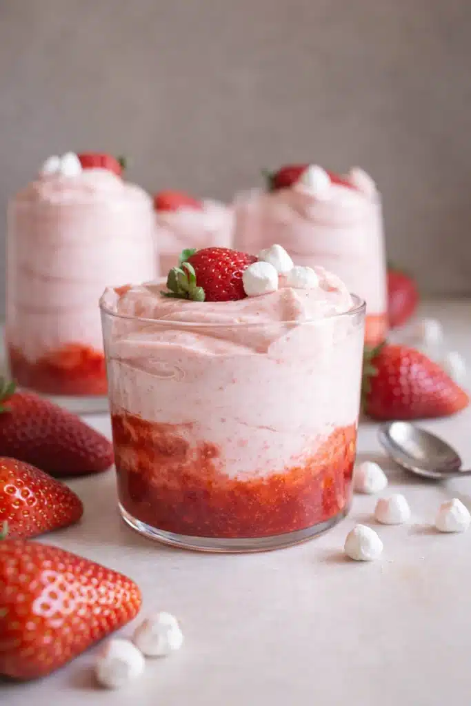 Fresh strawberry mousse layered with strawberry puree in a glass dessert cup
