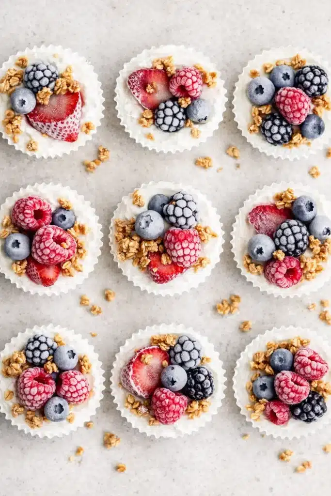Frozen Yogurt Granola Cups topped with strawberries, raspberries, blueberries and granola