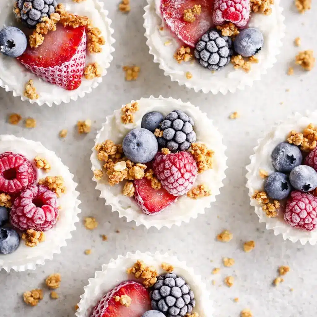 Frozen Yogurt Granola Cups topped with strawberries raspberries blueberries and granola