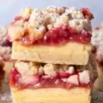Gluten free rhubarb crumble bars with custard layer and buttery shortbread crust