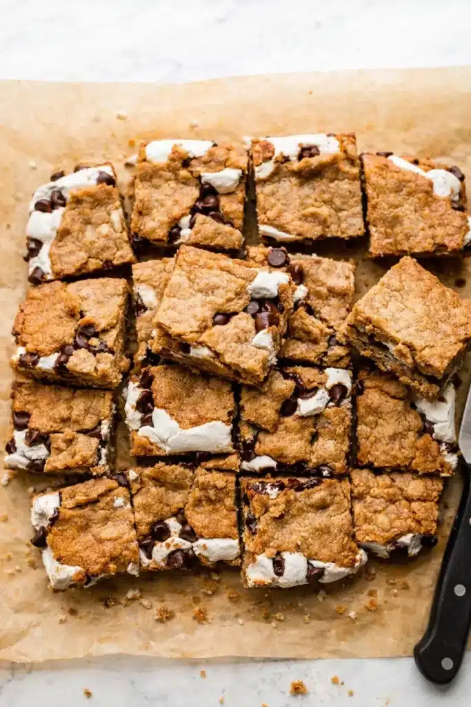S’mores cookie bars cut into squares with marshmallow and chocolate chips