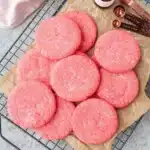 Mexican pink cookies with sugar topping on parchment paper cooling rack