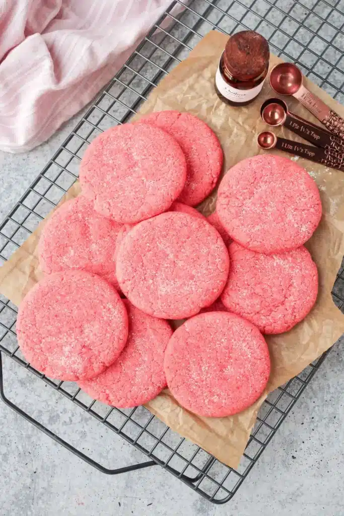 Mexican pink cookies with sugar topping on parchment paper cooling rack