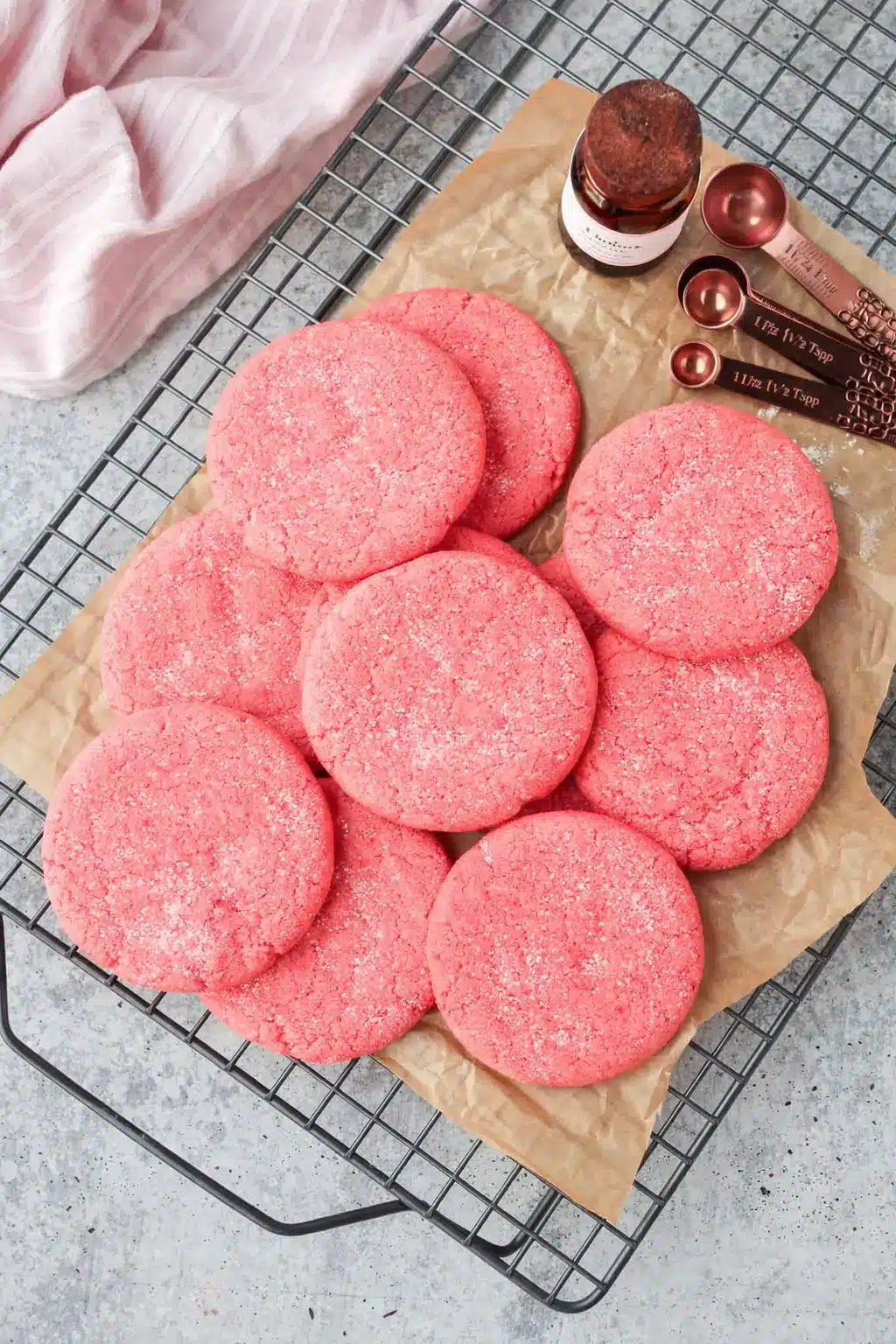 Mexican pink cookies with sugar topping on parchment paper cooling rack