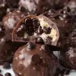 Chocolate covered no-bake cookie dough bites with mini chocolate chips and creamy cookie dough center