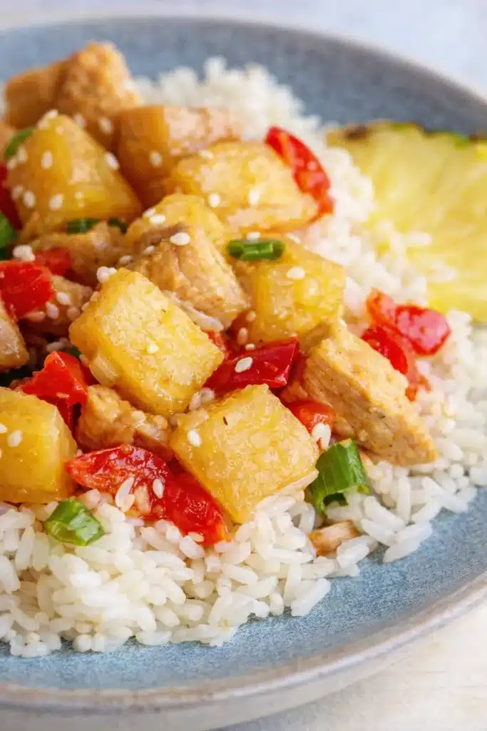 Pineapple Chicken and Rice Skillet Easy Amazing Dinner 5 Pineapple Chicken and Rice Skillet served over white rice with pineapple, chicken, and red bell pepper