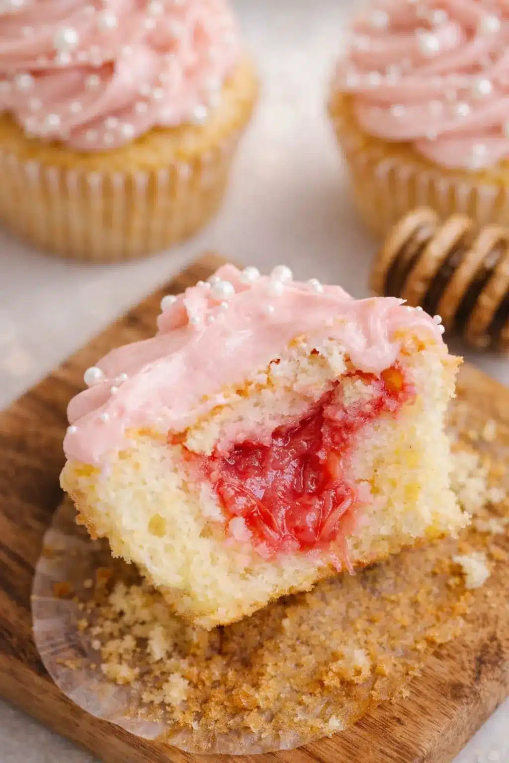 Rhubarb honey cupcake with pink frosting and sweet tart rhubarb filling