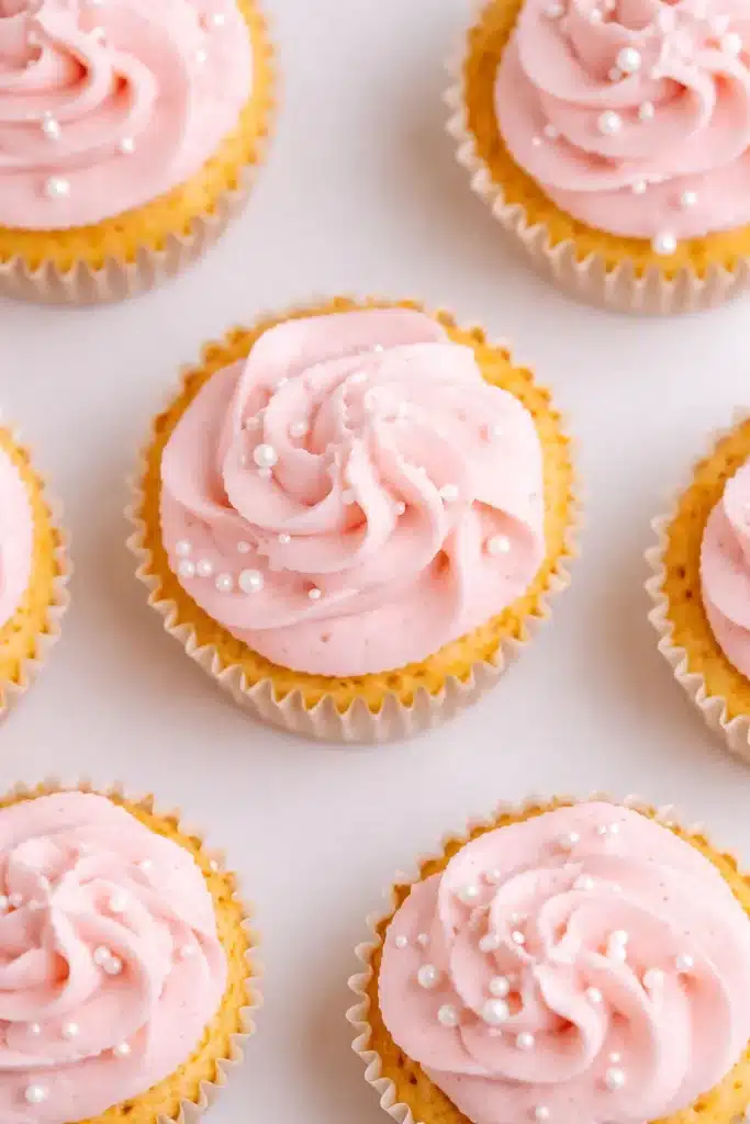 Rhubarb Honey Cupcakes with pink buttercream and white sugar pearls
