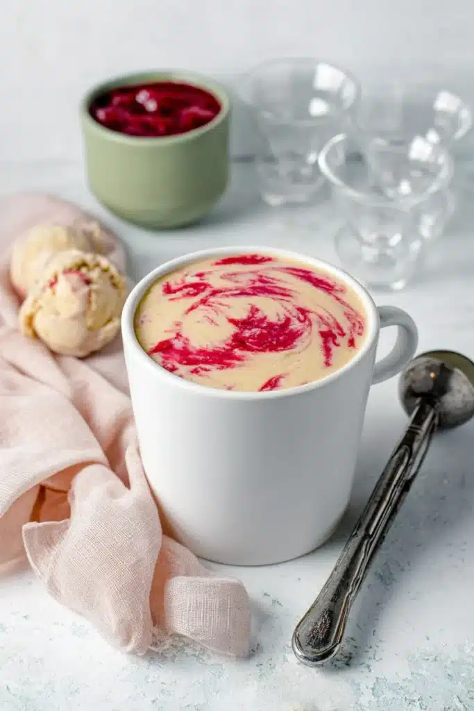 Rhubarb Ice Cream in a pint container with bright rhubarb swirls