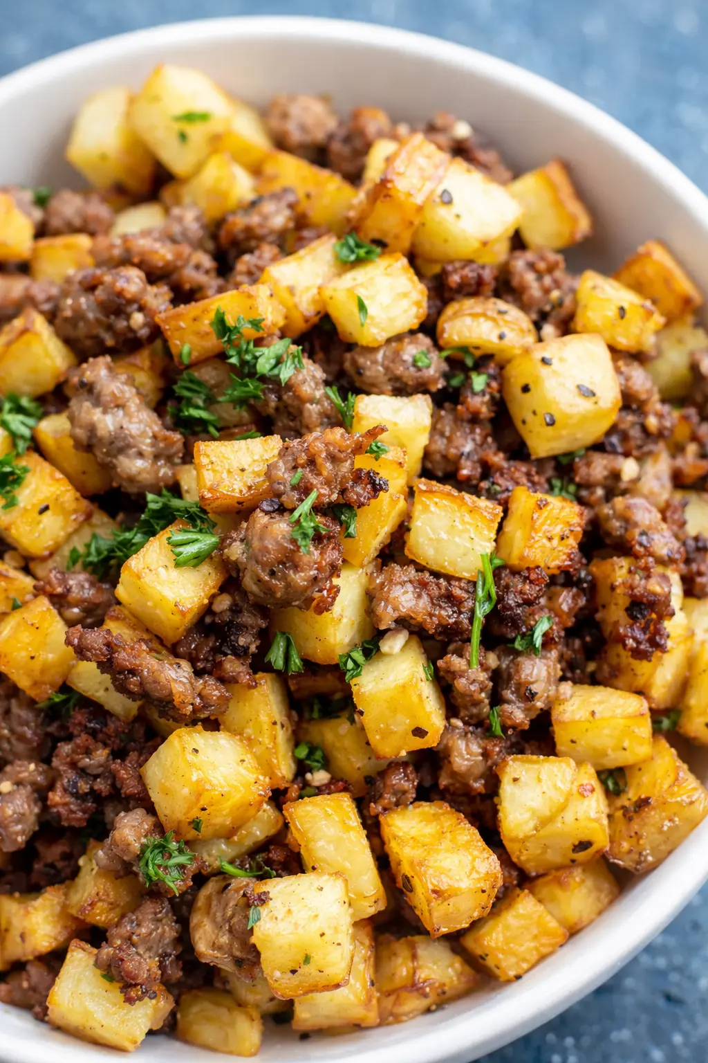 Sausage and potatoes breakfast hash with crispy potatoes and browned sausage in a bowl