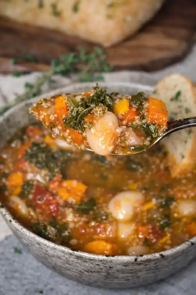spoonful of winter minestrone soup with beans vegetables and quinoa