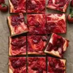 Strawberry cheesecake brownies with glossy fruit swirl and fudgy chocolate base