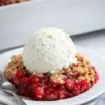 Strawberry crumble with vanilla ice cream on a plate
