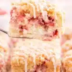 Strawberry Rhubarb Cake Recipe That Feels Amazing 5 Strawberry rhubarb cake slice with crumb topping and vanilla glaze