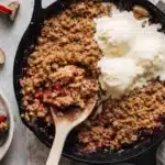Strawberry Rhubarb Crisp Easy Amazing Sweet Tart Treat 5 Strawberry rhubarb crisp with oat topping and vanilla ice cream in a baking dish