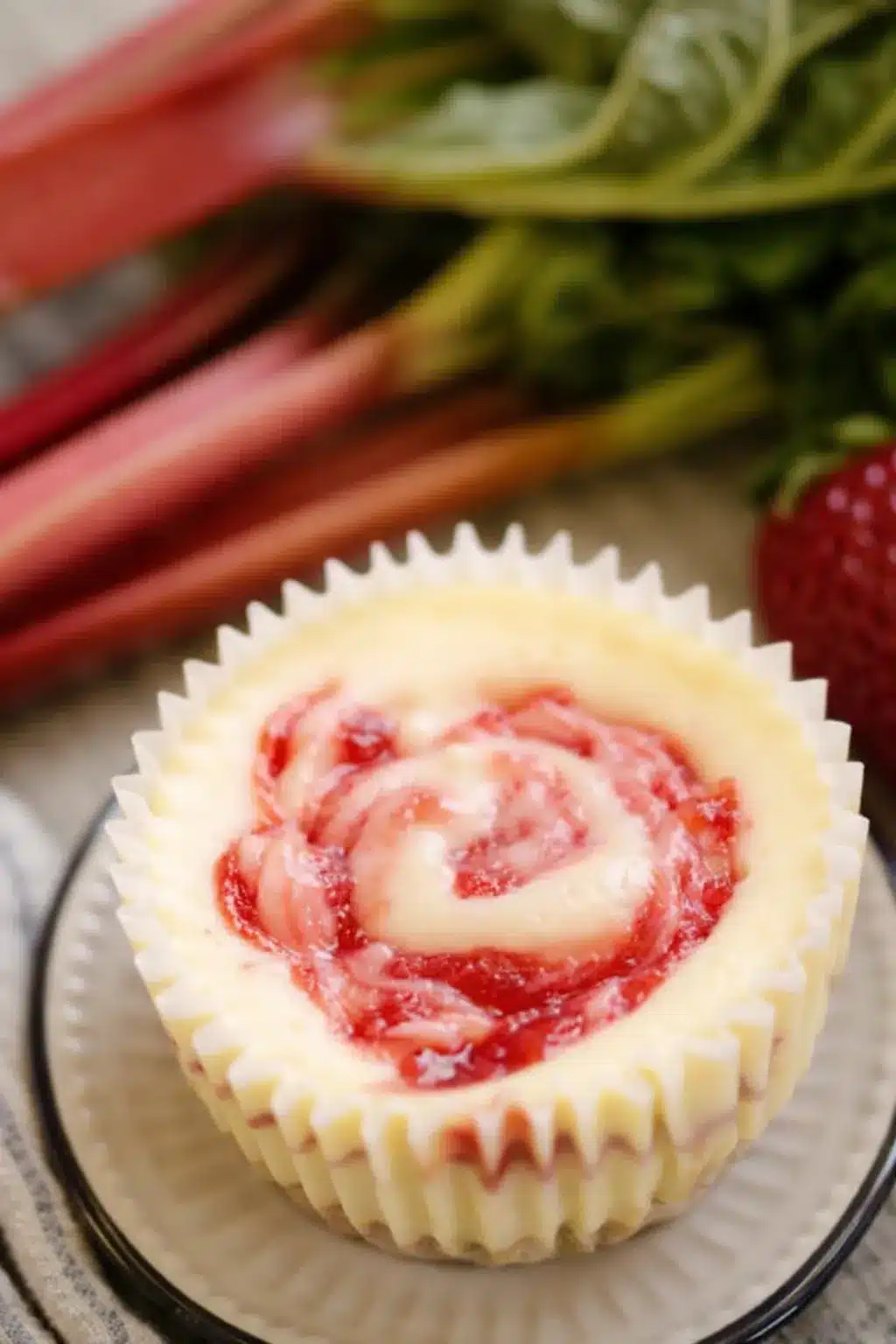 Strawberry rhubarb mini cheesecake with creamy filling and fruit swirl